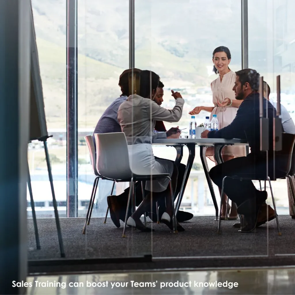Colleagues sat round a meeting table in a conference room