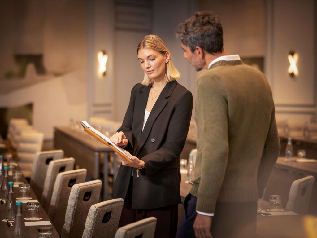 Hospitality consultant reviewing hotel facilities as part of outsourcing in hospitality industry