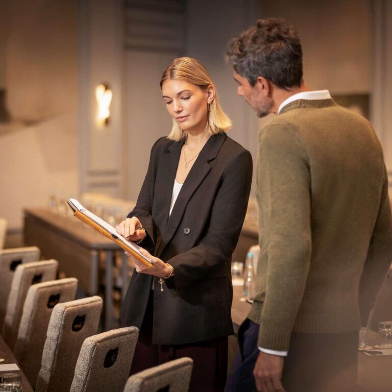 Hospitality consultant reviewing hotel facilities as part of outsourcing in hospitality industry